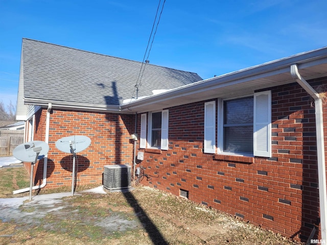 view of side of home featuring central AC