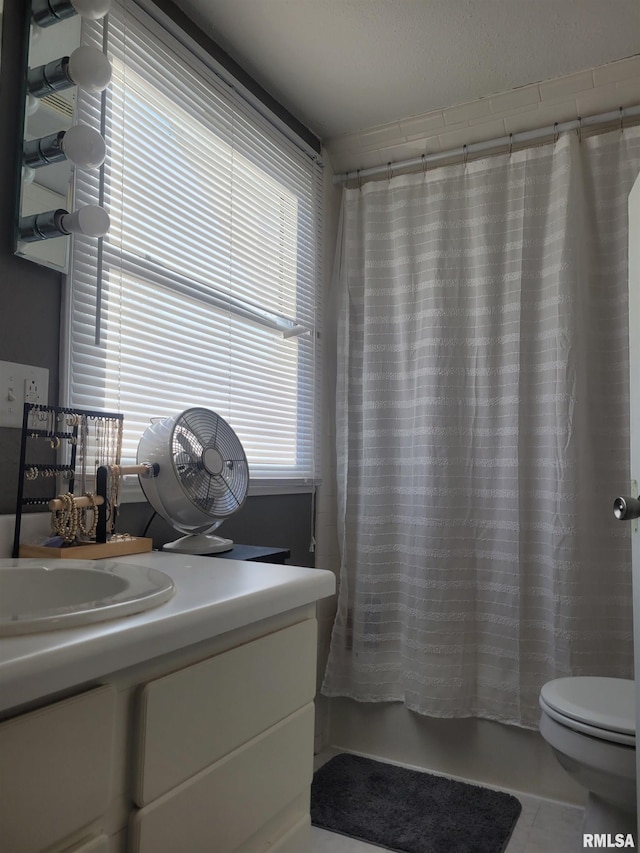 full bathroom featuring toilet, sink, and shower / bath combo with shower curtain