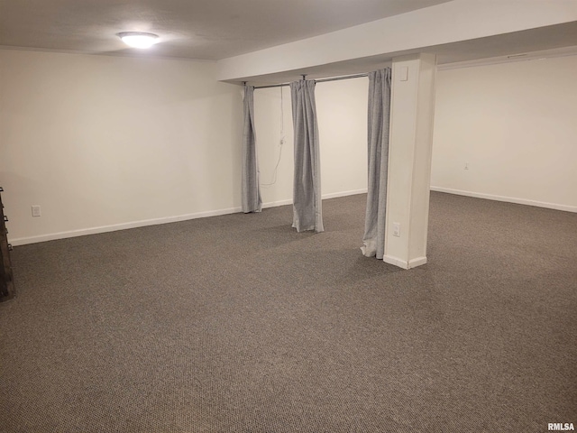 basement featuring dark carpet