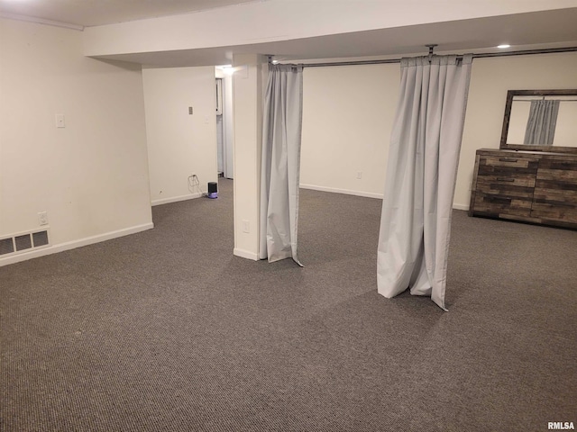 basement featuring dark colored carpet