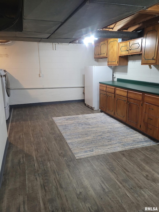 washroom featuring cabinets, washing machine and dryer, and dark hardwood / wood-style floors