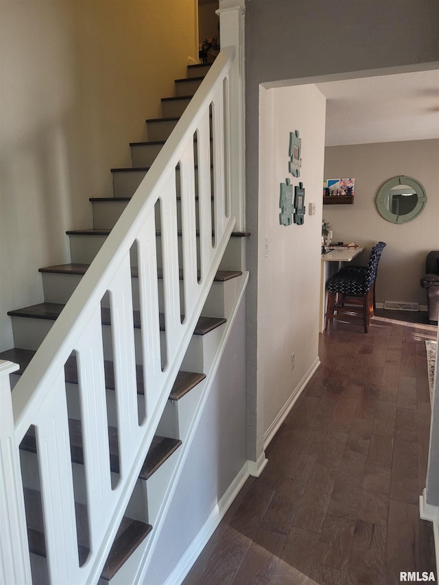 stairway with hardwood / wood-style flooring