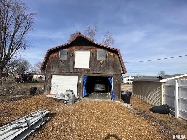 view of side of property with an outbuilding and a garage