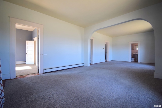 spare room with a baseboard radiator and carpet