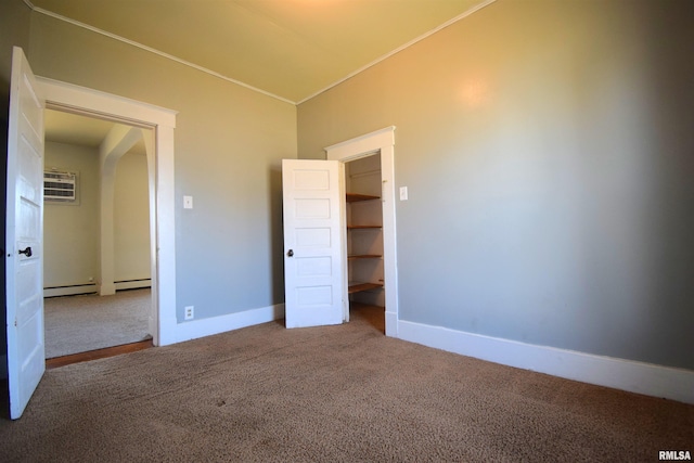 unfurnished bedroom featuring baseboard heating, carpet flooring, and a wall unit AC