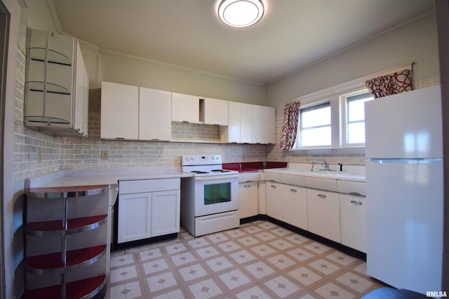 kitchen with tasteful backsplash, sink, white appliances, and white cabinets