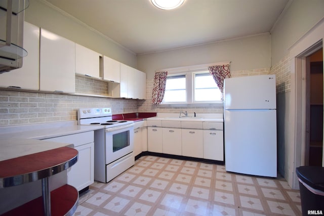 kitchen with white cabinetry, white appliances, sink, and backsplash