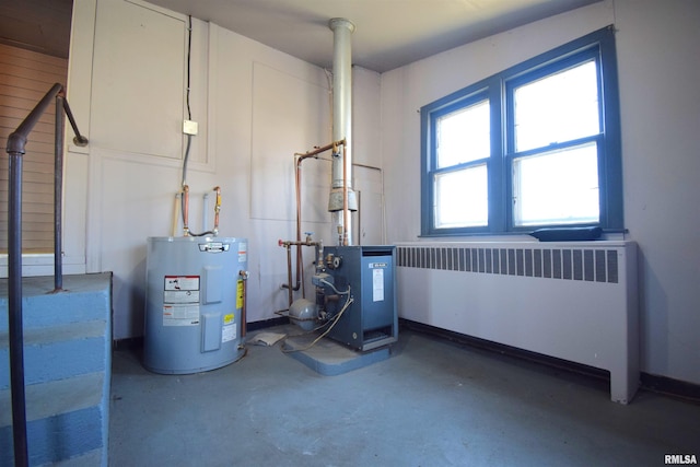 utility room featuring radiator heating unit and water heater