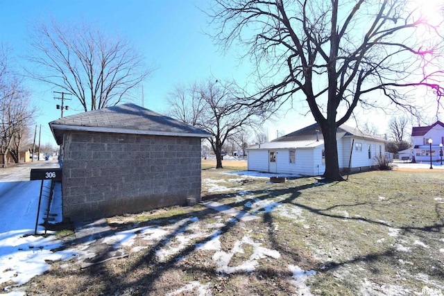 view of side of home featuring an outbuilding