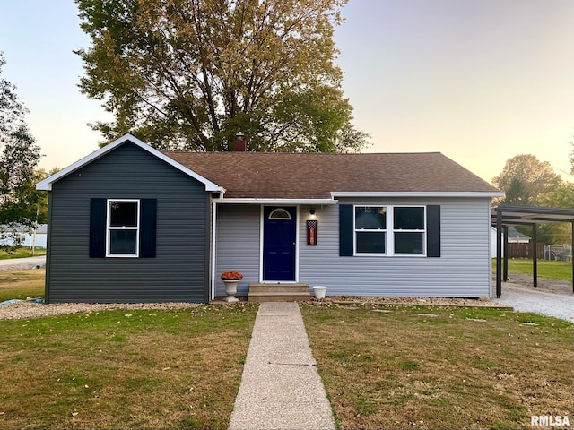 single story home with a carport and a lawn