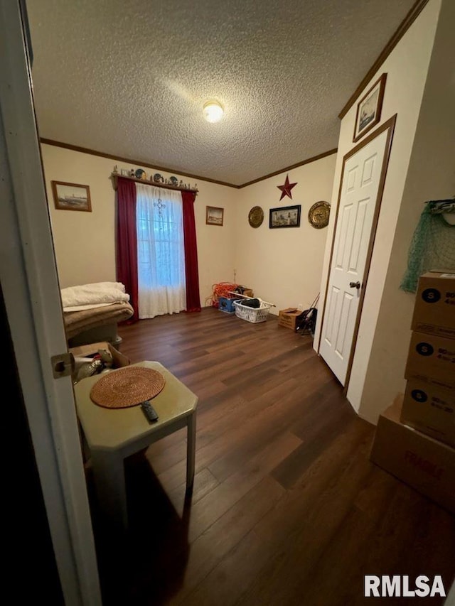 bedroom featuring a textured ceiling and dark hardwood / wood-style flooring