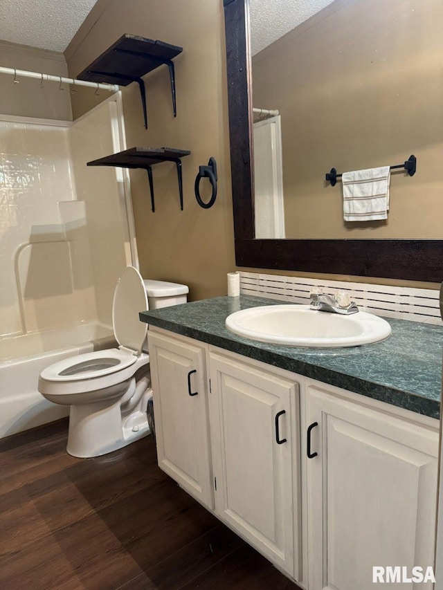 full bathroom featuring shower / tub combination, wood-type flooring, vanity, toilet, and a textured ceiling