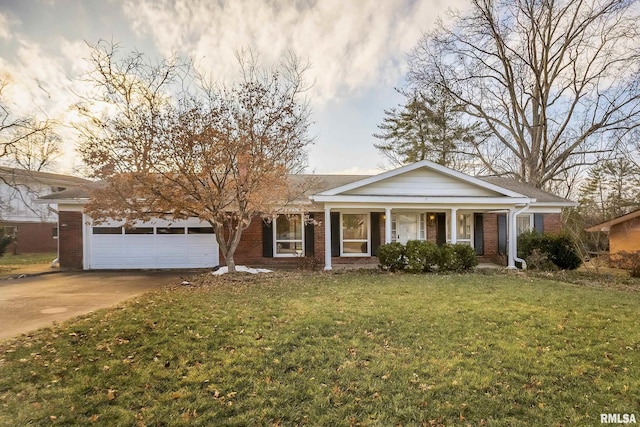 ranch-style house featuring a garage, a front yard, and a porch