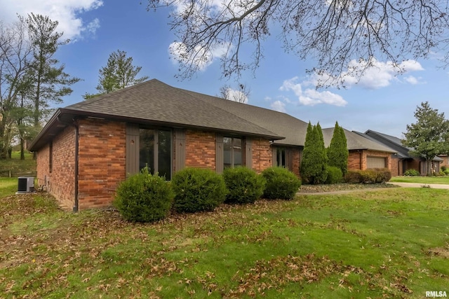 exterior space with central AC unit and a front lawn