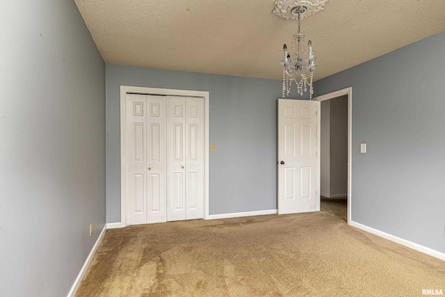 unfurnished bedroom featuring carpet flooring, a closet, and a textured ceiling