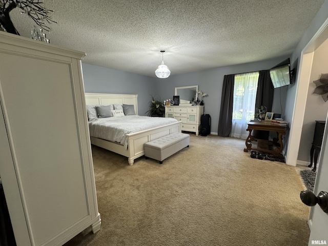 bedroom featuring light carpet and a textured ceiling