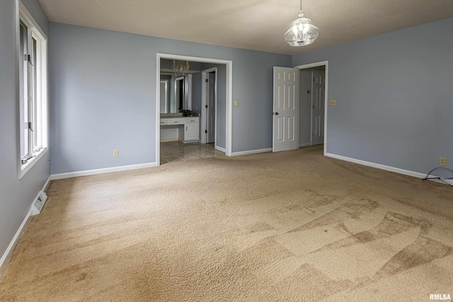unfurnished bedroom featuring light carpet