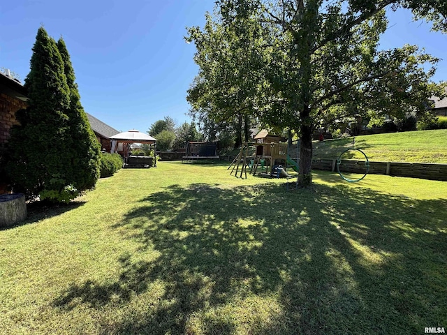 view of yard with a trampoline, a gazebo, and a playground