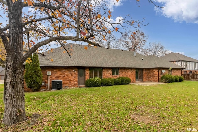 rear view of house with cooling unit, a yard, and a patio area