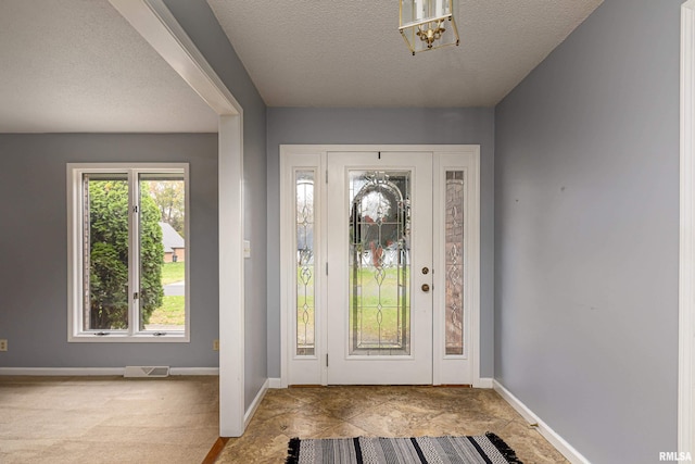 entryway featuring a textured ceiling