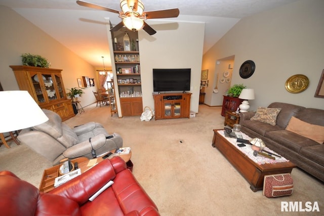 carpeted living room with ceiling fan with notable chandelier and vaulted ceiling