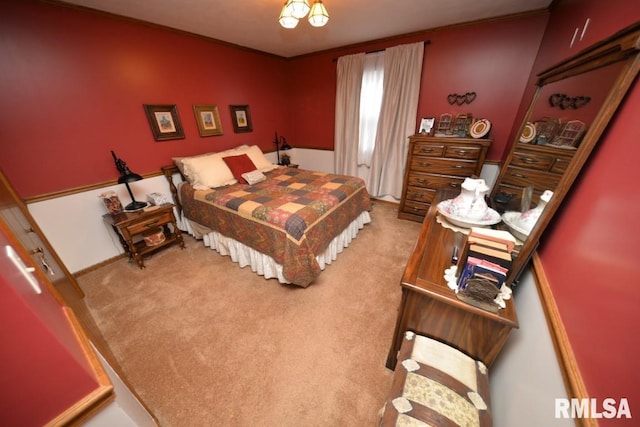 bedroom featuring crown molding and carpet