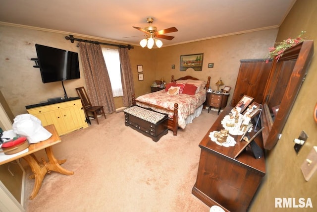 bedroom with crown molding, ceiling fan, and carpet flooring