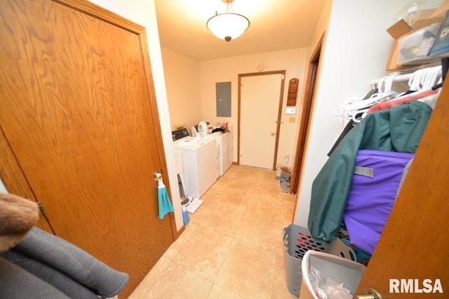 clothes washing area featuring separate washer and dryer, light tile patterned floors, and electric panel