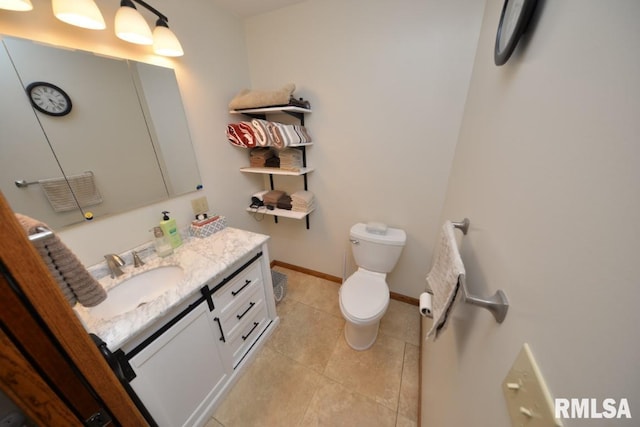 bathroom featuring vanity, tile patterned floors, and toilet