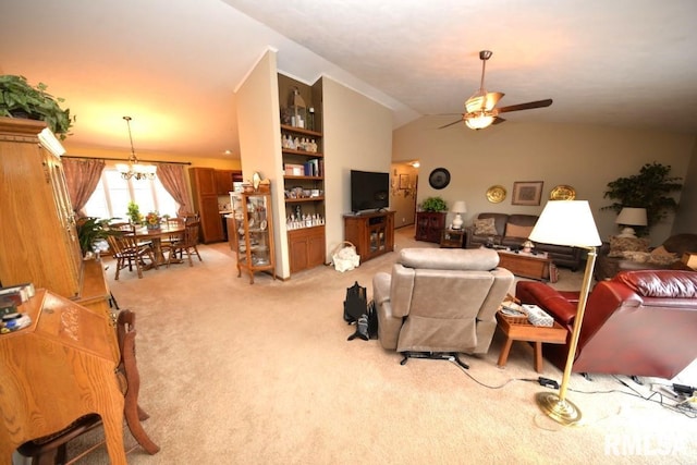 carpeted living room with lofted ceiling, built in shelves, and ceiling fan with notable chandelier