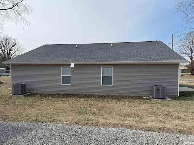 view of home's exterior featuring cooling unit and a yard