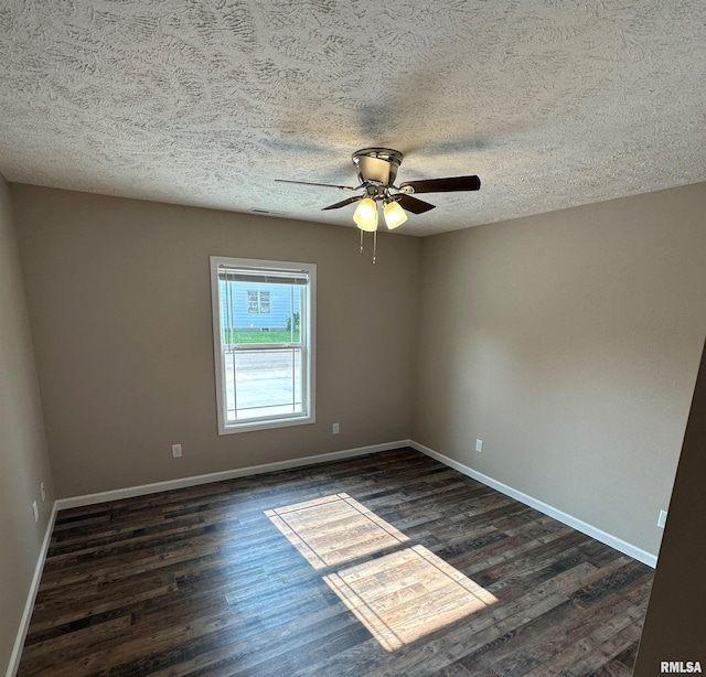 empty room featuring ceiling fan, a textured ceiling, and dark hardwood / wood-style flooring