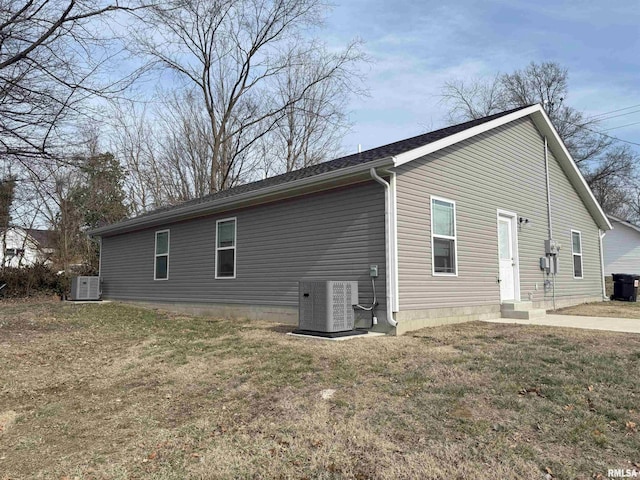 view of home's exterior featuring a yard and cooling unit