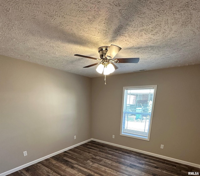 empty room with ceiling fan, dark hardwood / wood-style floors, and a textured ceiling