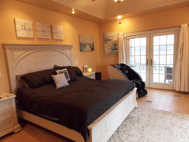 bedroom with light tile patterned floors, access to outside, french doors, and vaulted ceiling