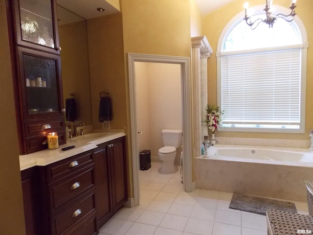 bathroom featuring tile patterned flooring, vanity, a tub to relax in, toilet, and a chandelier