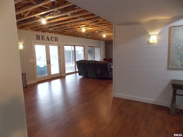 basement with french doors and dark hardwood / wood-style floors