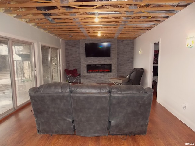 living room with dark wood-type flooring and a fireplace