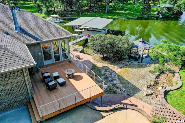 exterior space with a water view and a fire pit