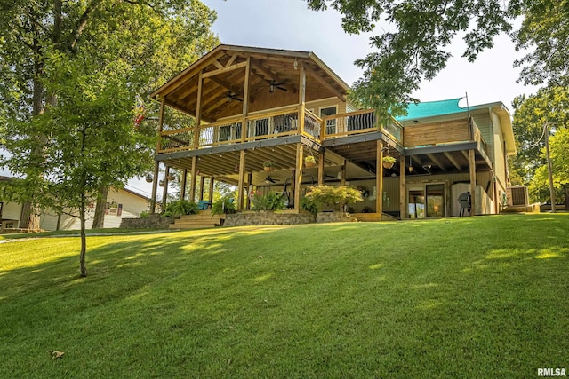 back of house with a lawn, ceiling fan, and a deck