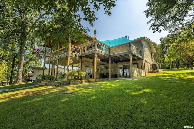 rear view of property featuring a wooden deck and a yard