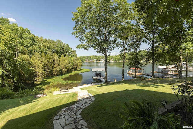 view of yard featuring a water view and a boat dock