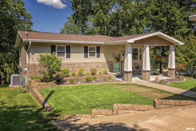 view of front of house featuring central AC unit and a front yard