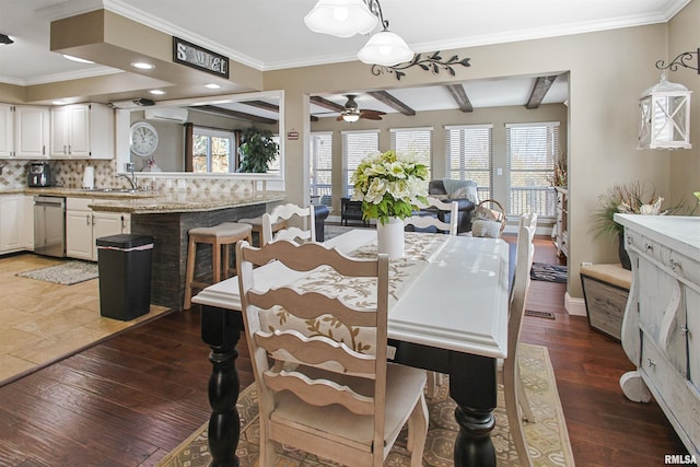 dining area featuring sink, ceiling fan, beam ceiling, ornamental molding, and dark hardwood / wood-style flooring