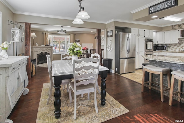 dining area featuring wood-type flooring and ornamental molding