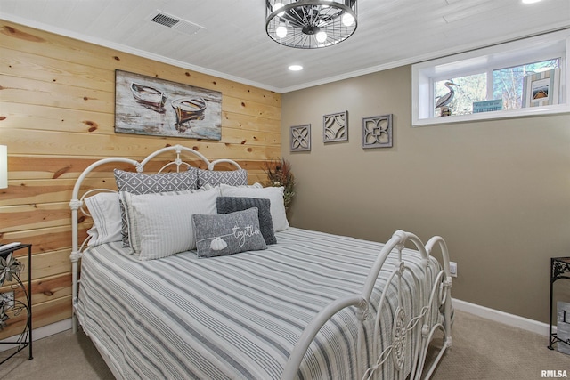 bedroom with crown molding, carpet flooring, and wood walls