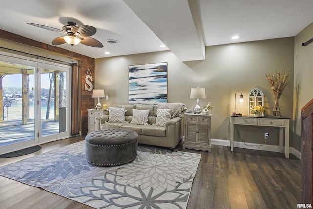 living room with dark hardwood / wood-style flooring and ceiling fan