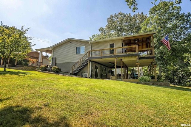 back of house with a wooden deck and a yard