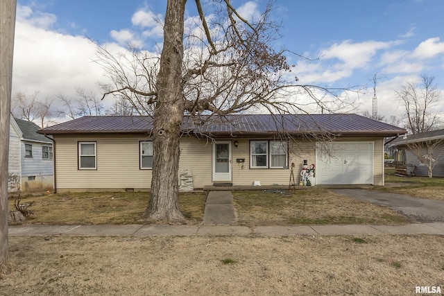 ranch-style house featuring a garage and a front yard