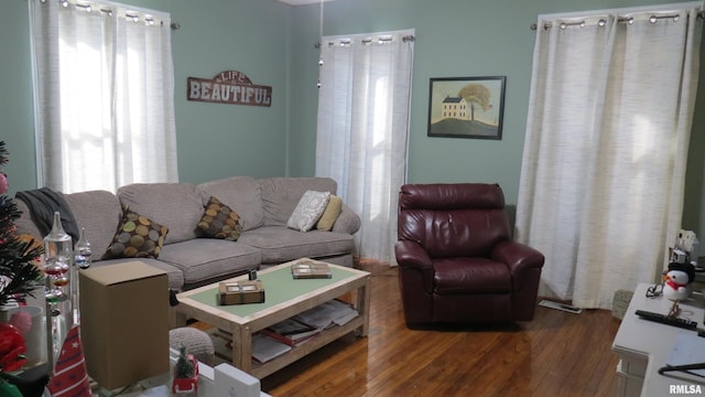 living room featuring a wealth of natural light and dark hardwood / wood-style flooring